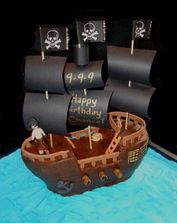 Cake pirate ship with eith black flags